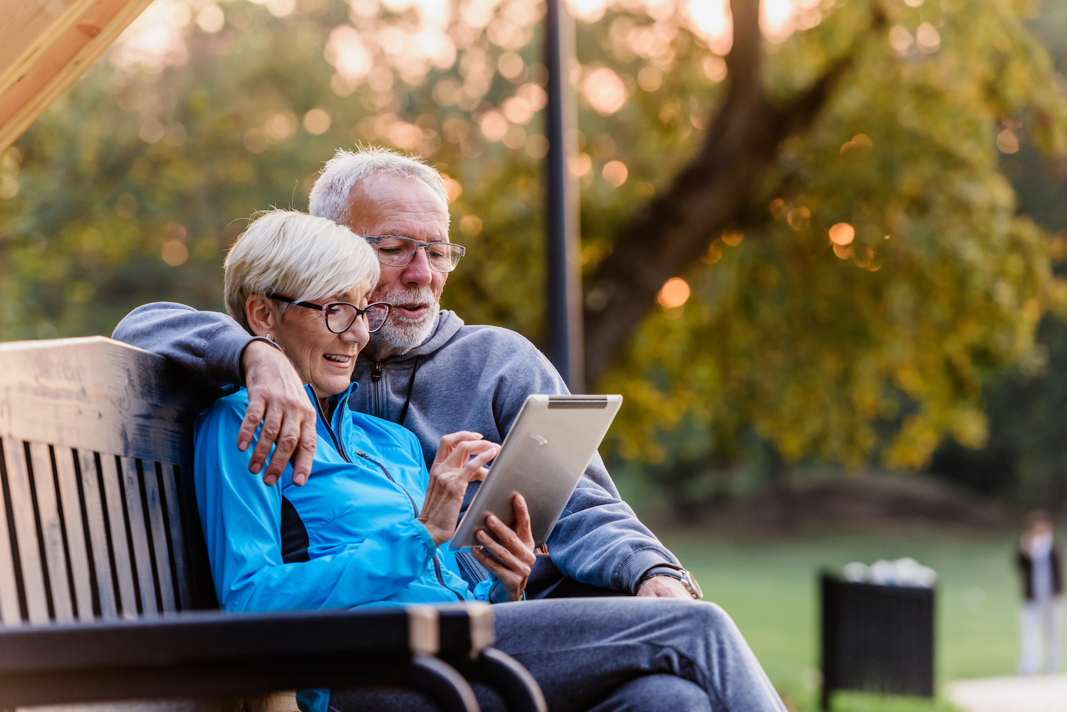 old couple reads on bench